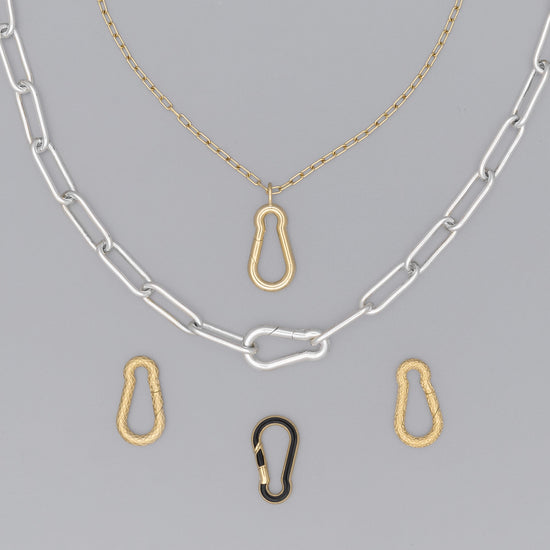 A series of carabiner-shaped invisible clasps in gold and silver colors, attached to a chain necklace.