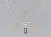 A series of carabiner-shaped invisible clasps in gold and silver colors, attached to a chain necklace.