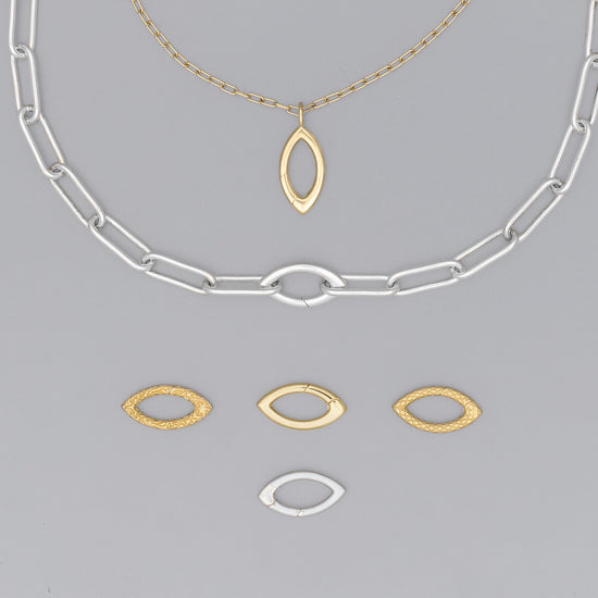 A collection of jewelry components, including a silver and gold-colored clasp with a marquise shape, and two arcs with incognito hinges.