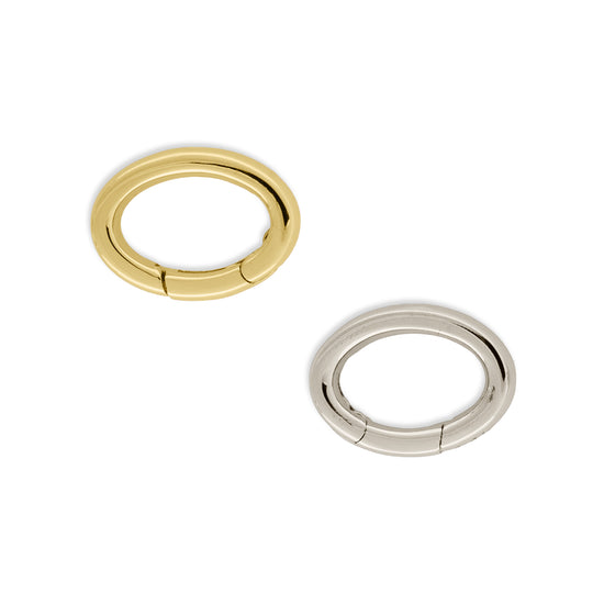 Two oval-shaped invisible clasps, one in gold color and the other in silver color, displayed against a white background.