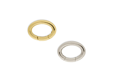Two oval-shaped invisible clasps, one in gold color and the other in silver color, displayed against a white background.