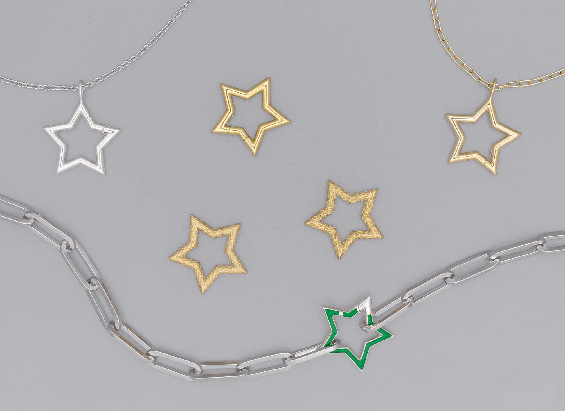 A series of star-shaped invisible clasps in various metals, some with charms attached, displayed against a neutral background.
