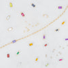 Colorful birthstone connectors and jewelry components on a light gray background
