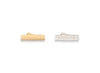 Two metallic objects, one gold and one silver, on a white background