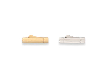 Two metallic objects, one gold and one silver, on a white background