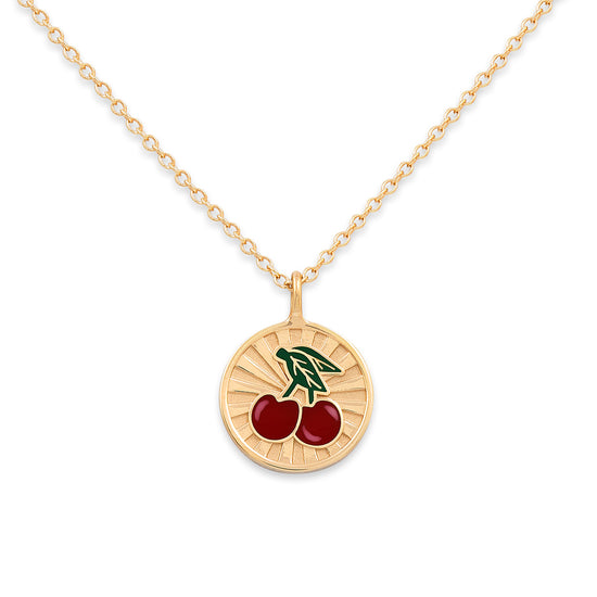 Gold necklace with a cherry pendant on a white background