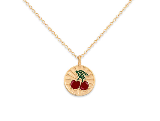 Gold necklace with a cherry pendant on a white background