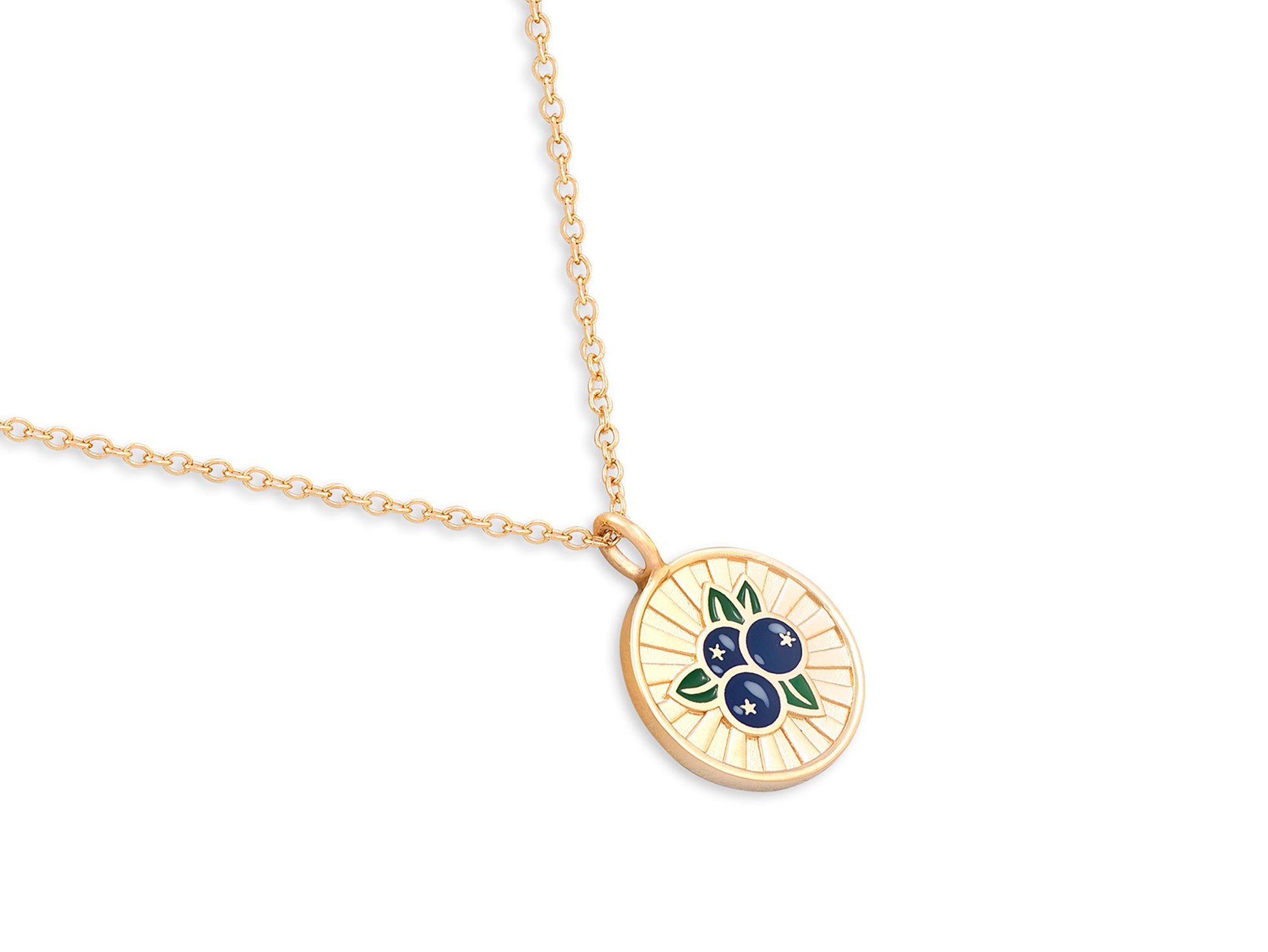 Gold necklace with a circular pendant featuring blueberries on a white background