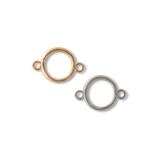 Two round connector clickers, one in 14K yellow gold and the other in 14K white gold, against a white background.