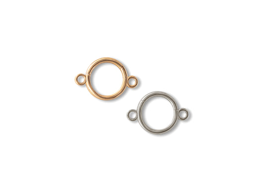 Two round connector clickers, one in 14K yellow gold and the other in 14K white gold, against a white background.