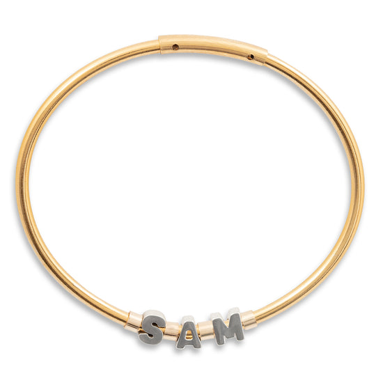 Gold bracelet with 'SAM' letters on a white background