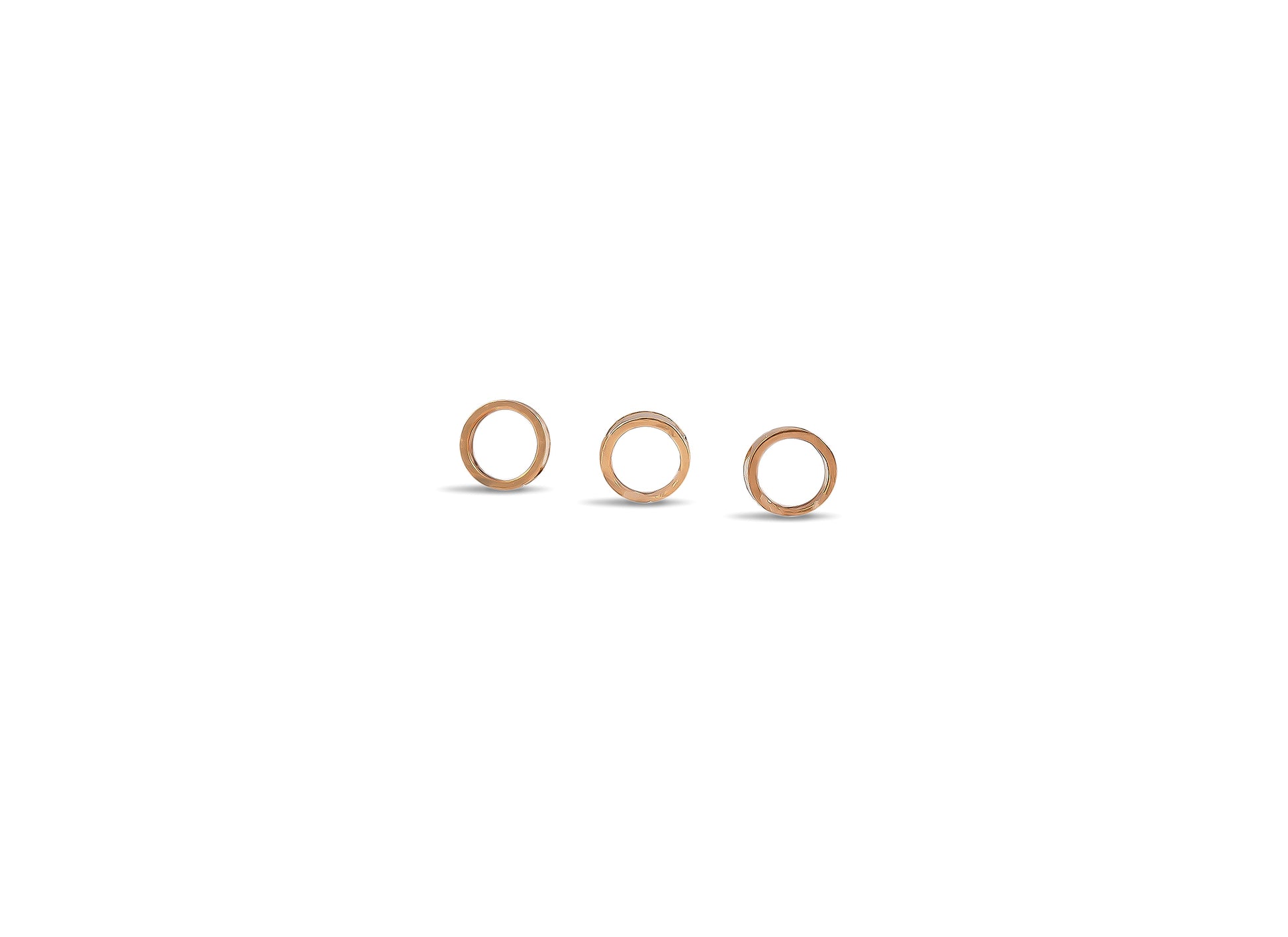 Three wooden rings of different sizes on a white background
