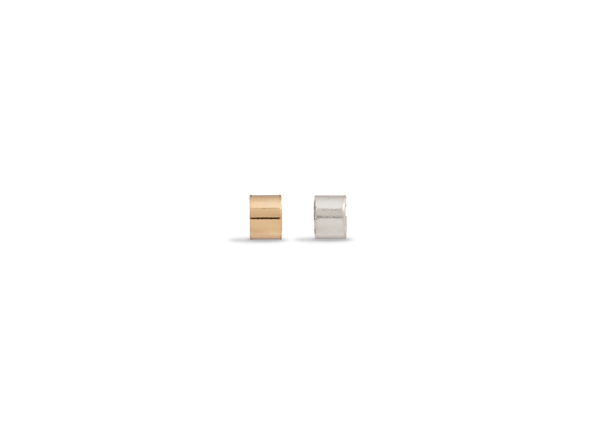Two small cylindrical containers, one gold and one silver, on a white background.