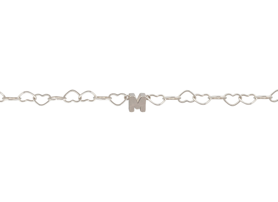 Silver bracelet with heart links and a letter 'M' charm on a white background.