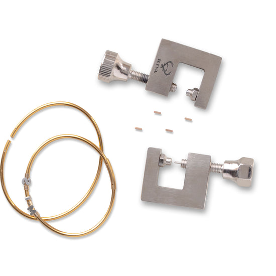 Metal hoop bracelets components with permanent jewelry hand tools on a white background