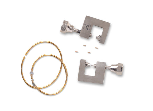 Metal hoop bracelets components with permanent jewelry hand tools on a white background