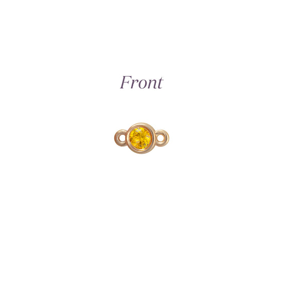 Gold connector with a yellow gemstone on a white background