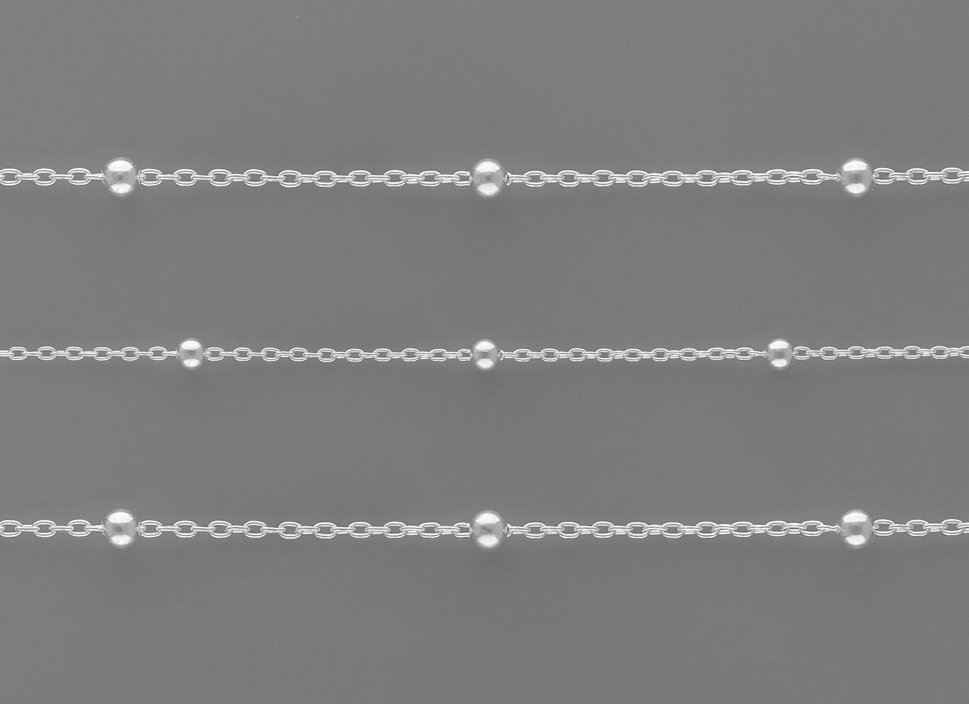 Satellite Chain By the Inch Chain 1: Features 1.58mm links made from 0.25mm wire and adorned with 2.45mm round satellite beads.
Chain 2: Crafted with 2mm links made from 0.3mm wire and accented with 2.98mm round satellite beads. Sterling Silver Necklace Jewelry Riva Ethical Bulk Made in USA, Brooklyn NY