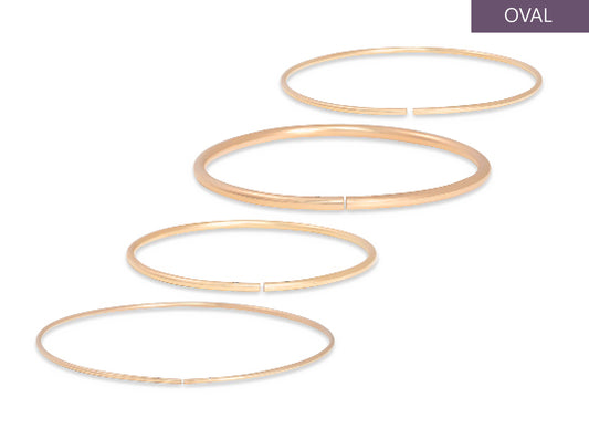 Set of gold permanent bangles on a white background