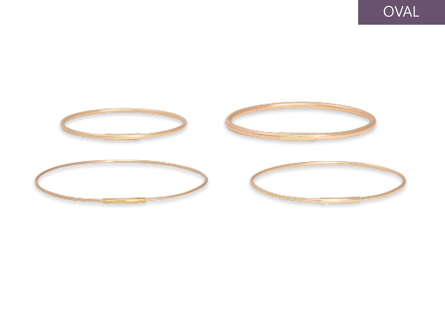 Four gold oval permanent bangles on a white background
