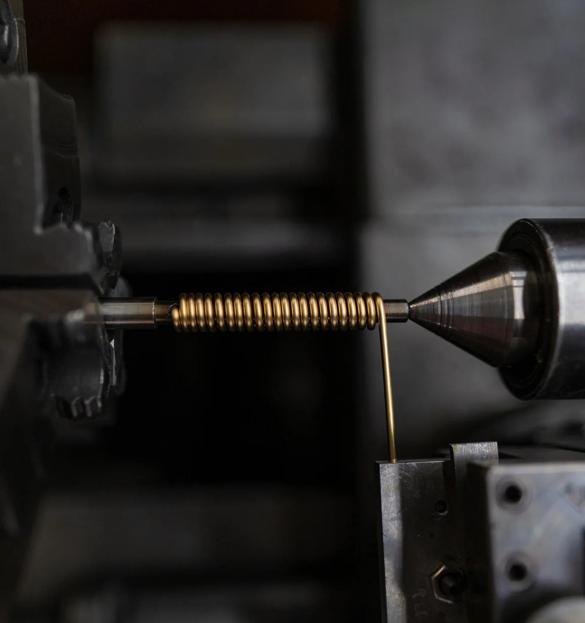 Close-up of a lathe machine in operation with a metal component being shaped.