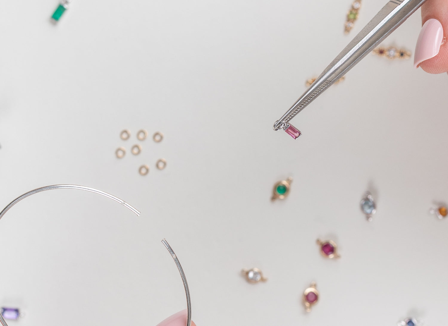 Baguette charm and sterling silver bangle on gray blurred background