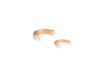 Gold bangle rings with pearl-like beads on a white background