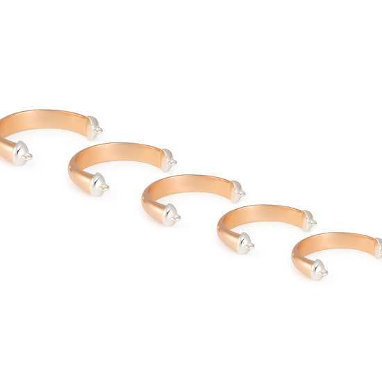 Set of five Cuff Rings with pearl-like beads on a white background