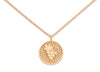 Gold necklace with a round pendant on a white background
