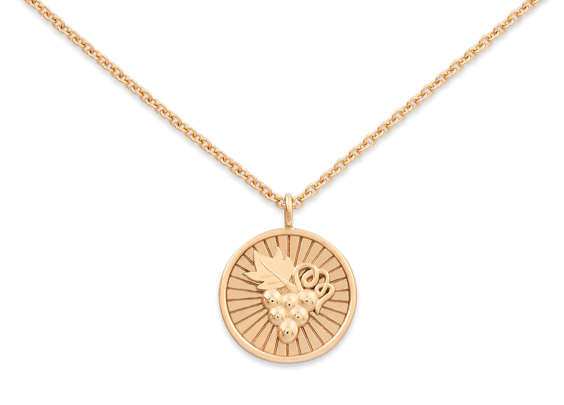 Gold necklace with a round pendant on a white background