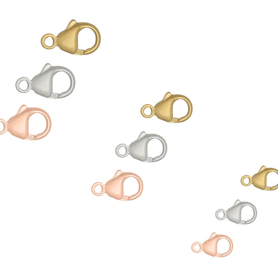Set of gold, silver, and rose gold lobster clasps on a white background