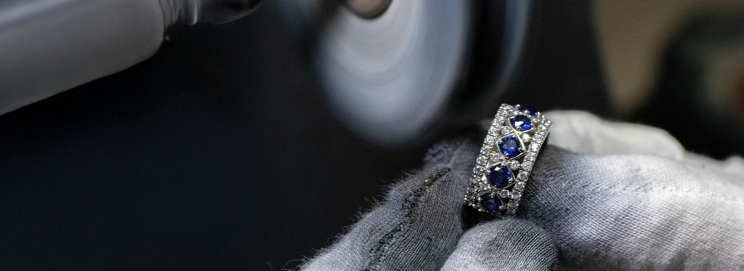 Diamond ring with blue stones on a dark surface