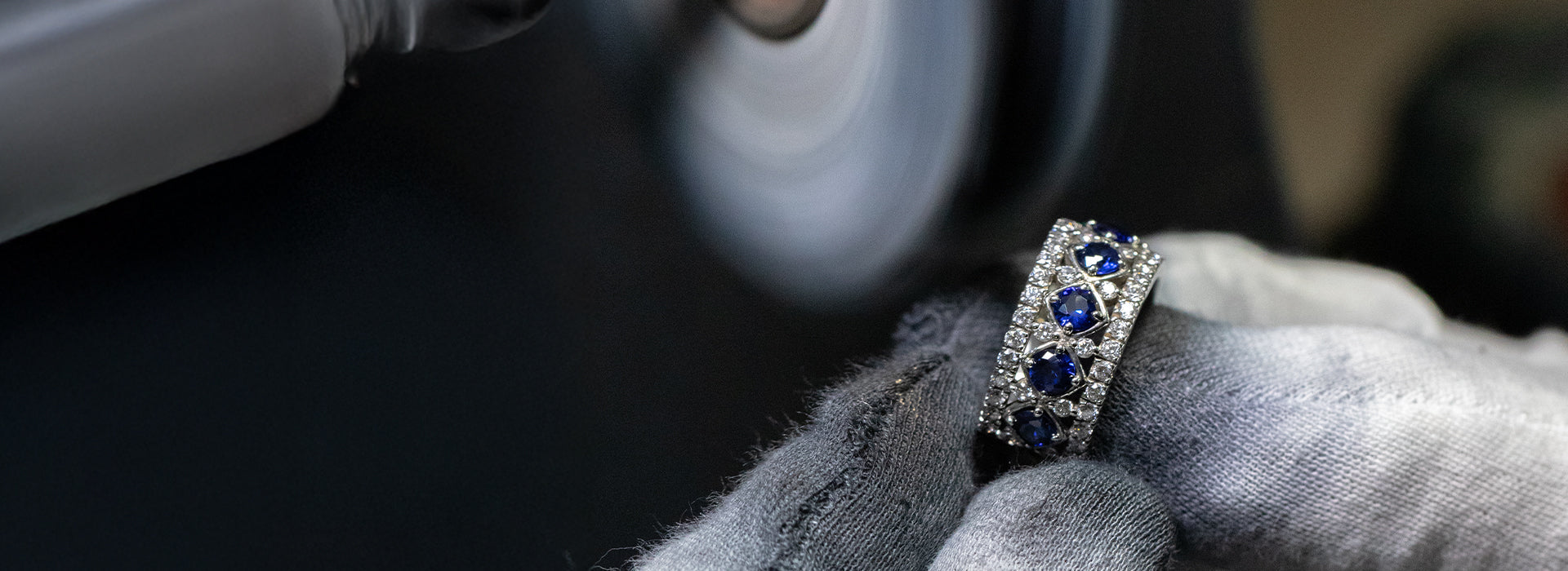 Diamond ring with blue stones on a dark surface