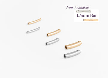 Set of gold, silver, and rose gold bar jewelry on a white background